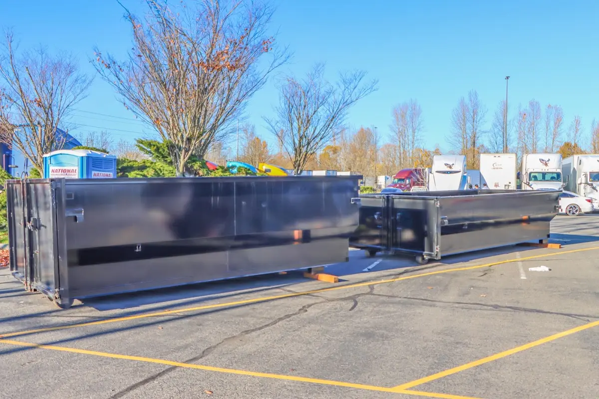 Professional dumpster rental service with roll-off container on residential driveway in Lehi